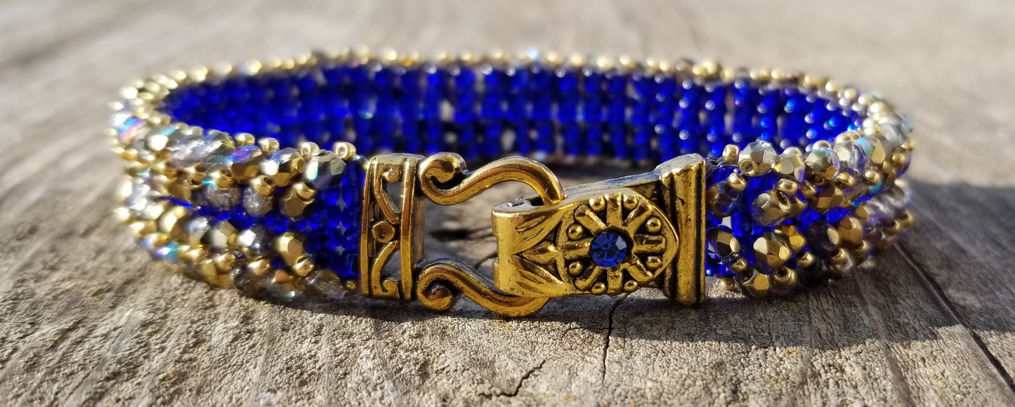 a close up of a bracelet on a wooden surface