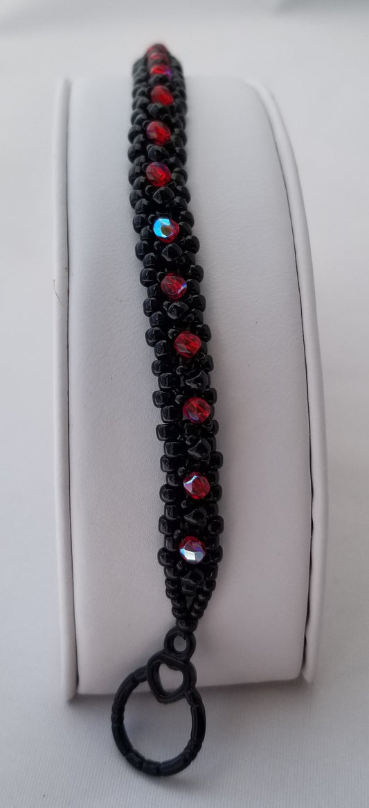 a black beaded bracelet with red and blue beads