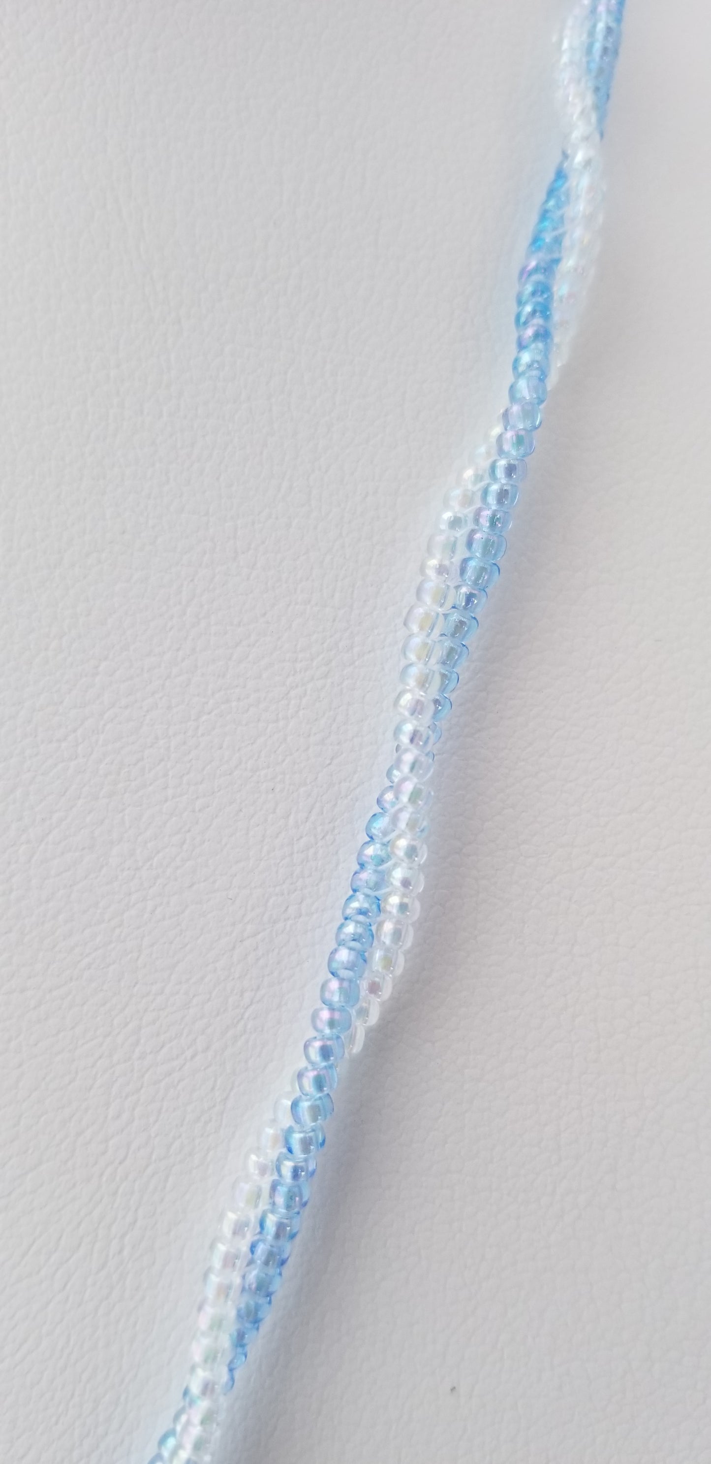 a close up of a white and blue ribbon on a white surface