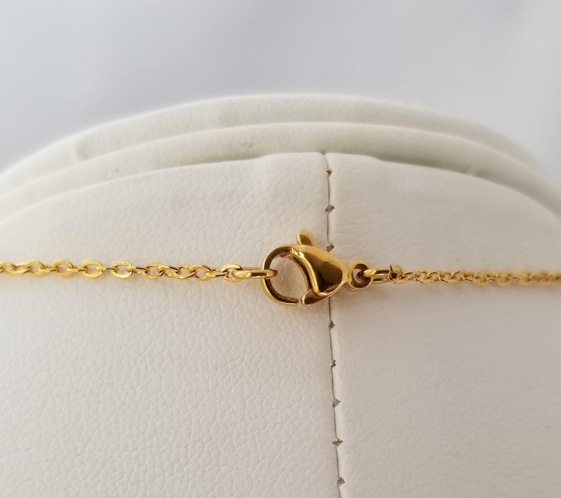 A close-up view of a gold chain necklace with a clasp and a clasp lock.