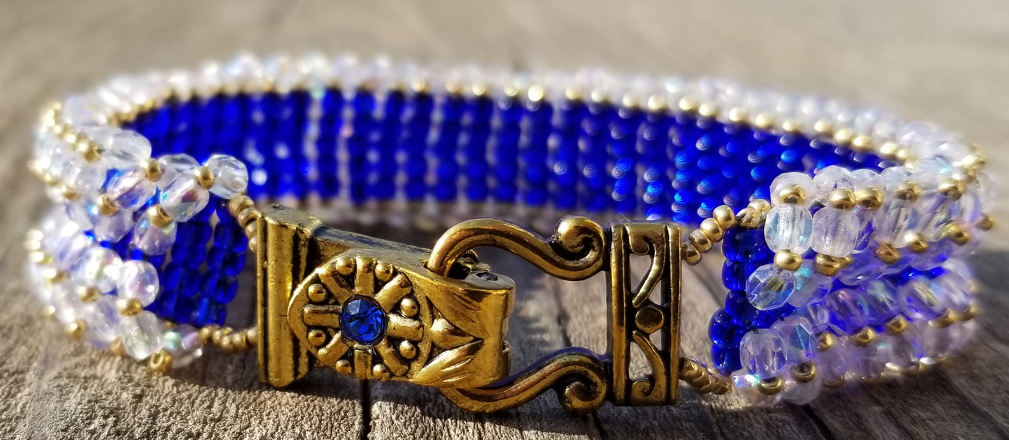 a close up of a bracelet on a wooden surface